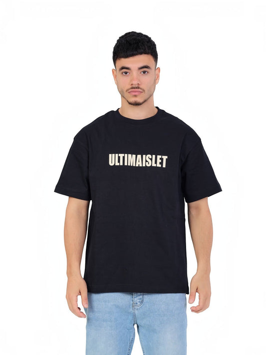 RUVR Bloc Tee in black heavyweight cotton with bold block-letter chest graphic worn by a man with light blue jeans