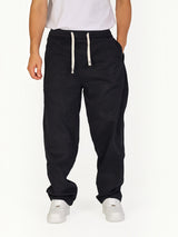 RUVR black Urban Utility Pants with an elastic drawstring waistband worn by a man in a relaxed modern fit