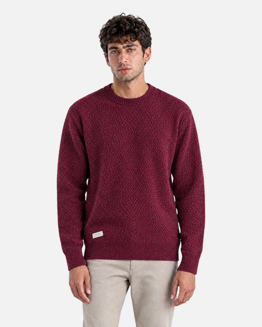 RUVR burgundy ribbed knit crew neck pullover worn by a man, featuring a structured fit and small brand label.