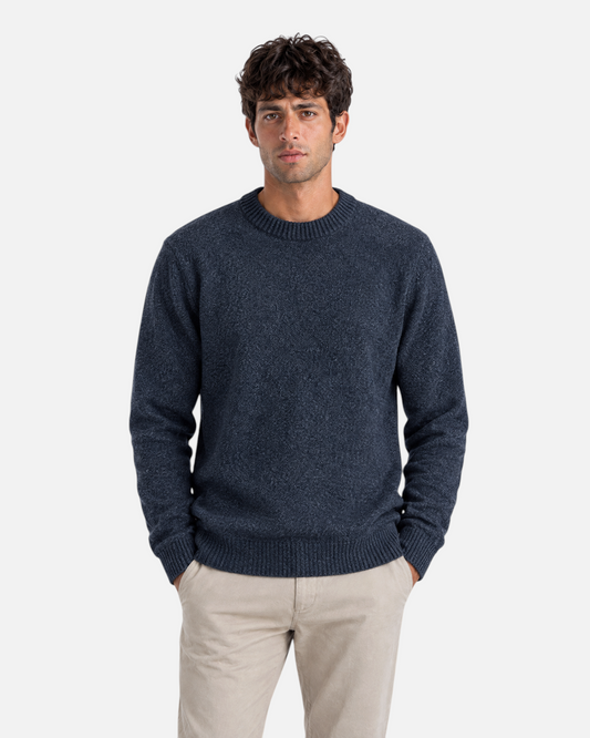 RUVR men's charcoal grey ribbed crew neck knit pullover with textured fabric worn with beige trousers