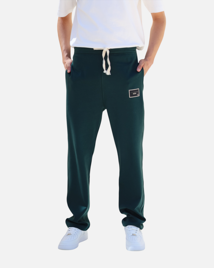 RUVR dark green heavyweight fleece sweatpants with a woven label patch and white drawstring on a model