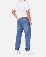 RUVR Ease relaxed fit blue denim jeans with a tapered leg and leather brand patch, worn from a back view.
