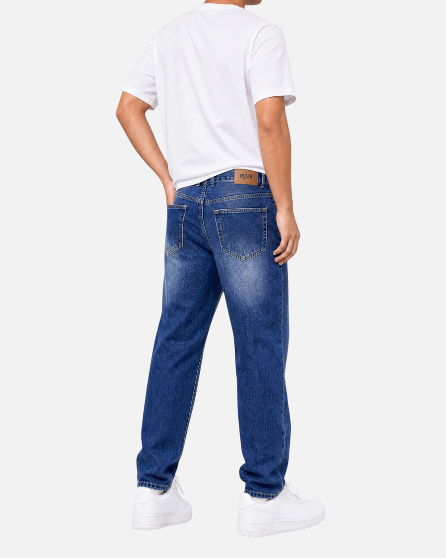 RUVR Ease Relaxed Fit Denim jeans in blue with a tapered leg and 5-pocket construction, viewed from the back.