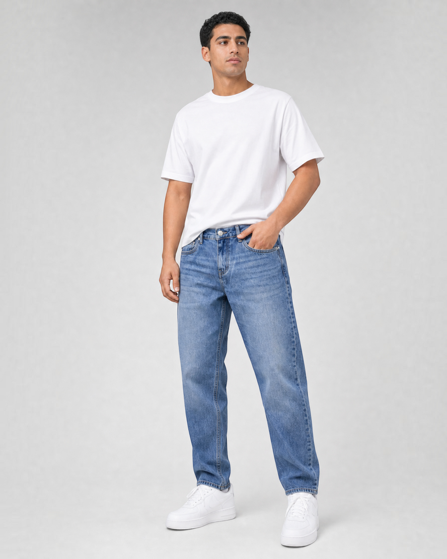 RUVR Ease Relaxed Fit Denim jeans in blue with a straight tapered leg and 5-pocket design worn by a male model