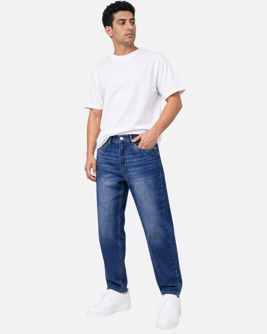 RUVR Ease relaxed fit blue denim jeans with a tapered leg and five-pocket design worn by a male model