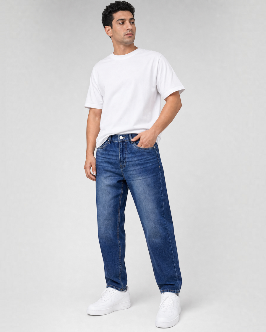 RUVR Ease Relaxed Fit Denim in blue worn by a male model with a white t-shirt and sneakers