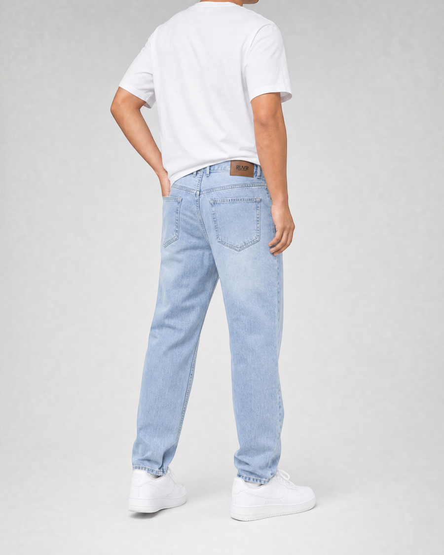 RUVR Ease Relaxed Fit Denim in sky blue with a tapered leg and five-pocket design, viewed from the back.