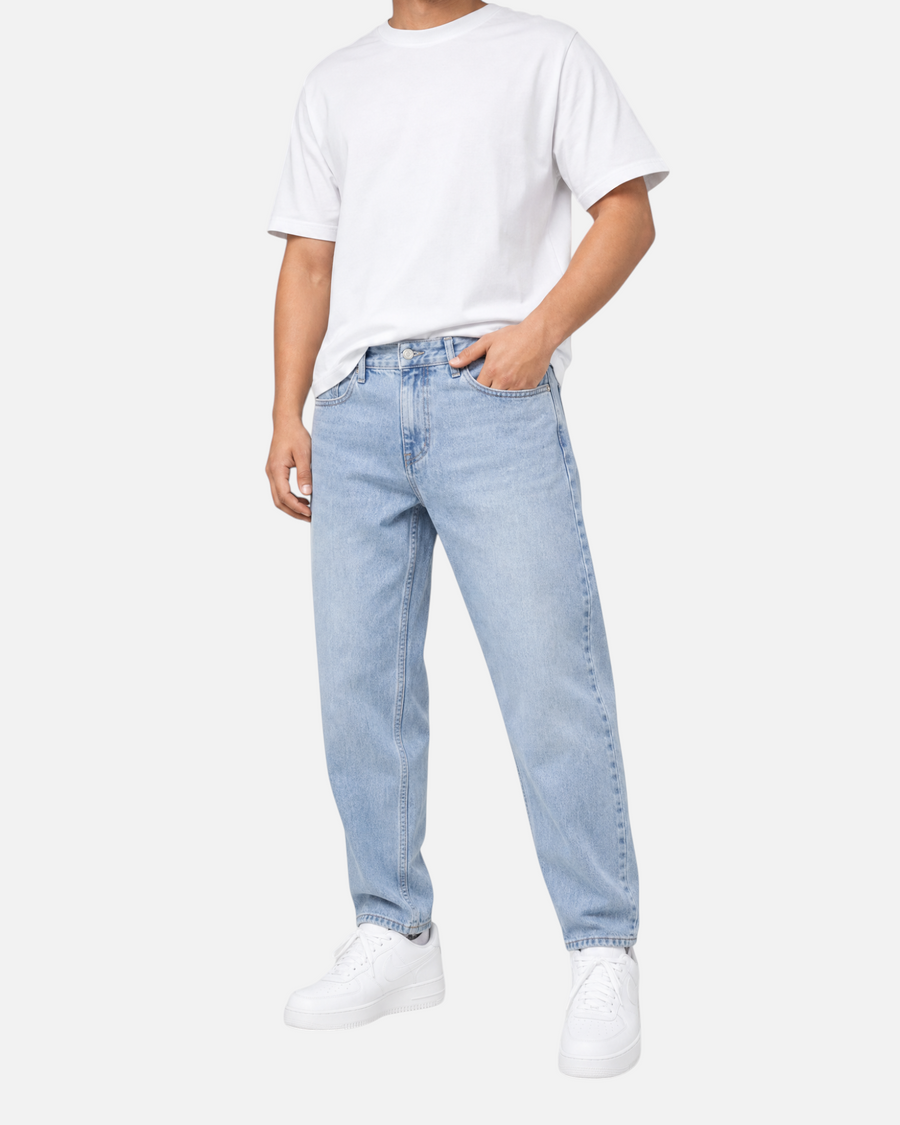 RUVR Ease Relaxed Fit Denim in sky blue with a tapered leg and classic five-pocket construction on a male model.