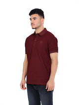 RUVR Essential Polo in burgundy cotton piqué with a classic collar, three-button placket, and tonal chest emblem.
