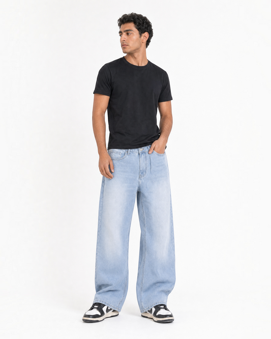 RUVR Fade Wide Leg Denim in sky blue with a relaxed fit and worn-in finish worn by a model in a black t-shirt