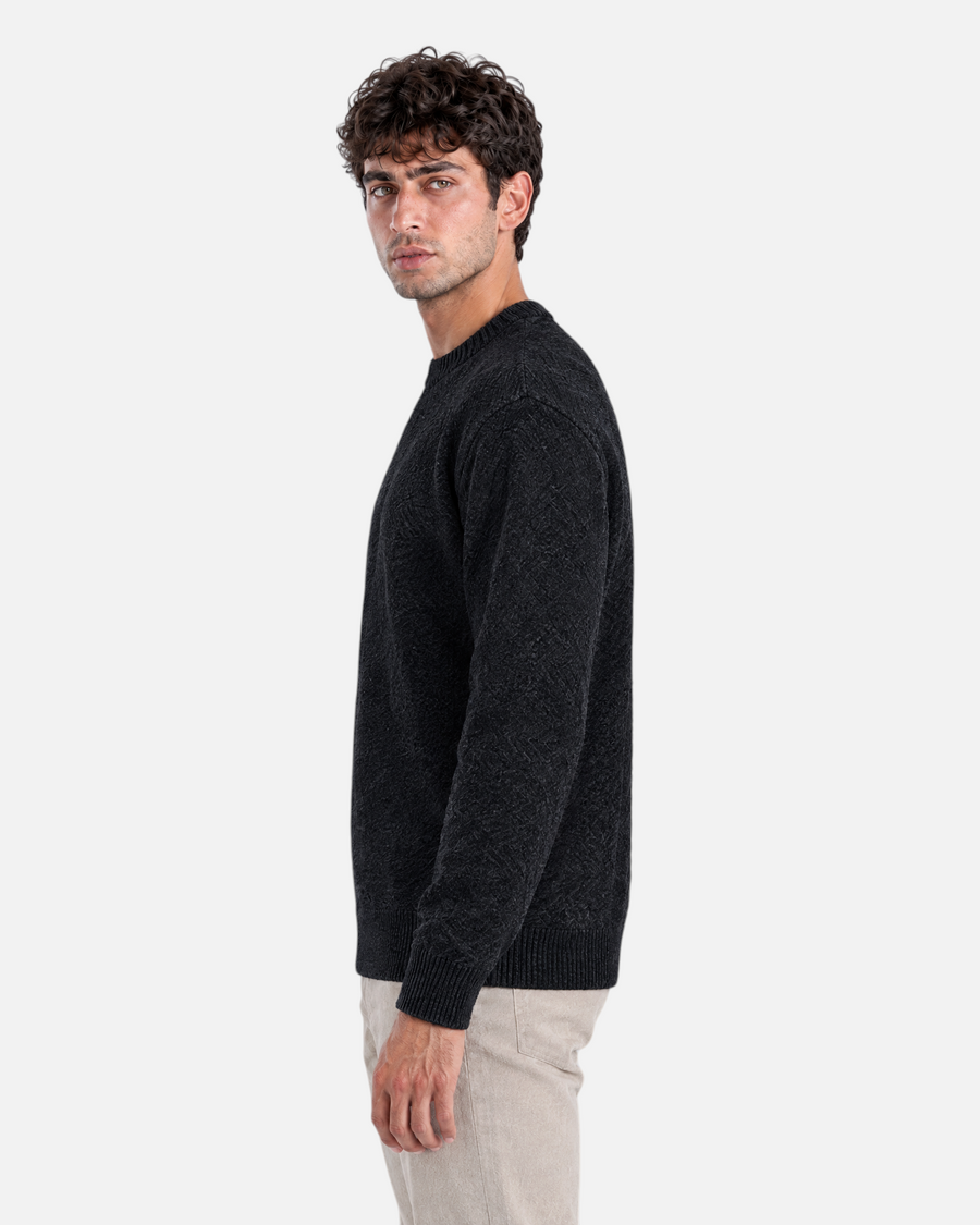 RUVR Grain black textured knit crew neck pullover worn by a man in a side profile view.