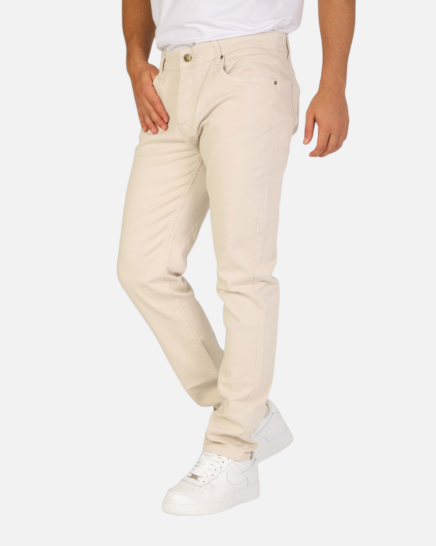 Model wearing RUVR Grain Denim straight fit trousers in cream heavyweight cotton twill with five-pocket styling