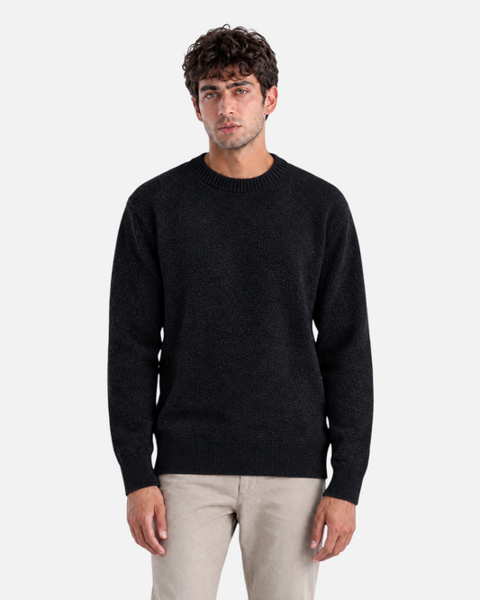 RUVR Grain Pullover in black featuring a textured knit crew neck design on a male model.