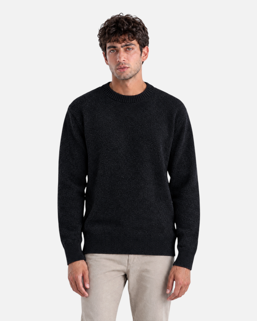 RUVR Grain Pullover in black featuring a textured knit crew neck design on a male model.