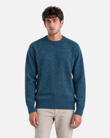 RUVR Grain pullover in petrol blue with a textured knit crew neck and clean silhouette worn by a man.