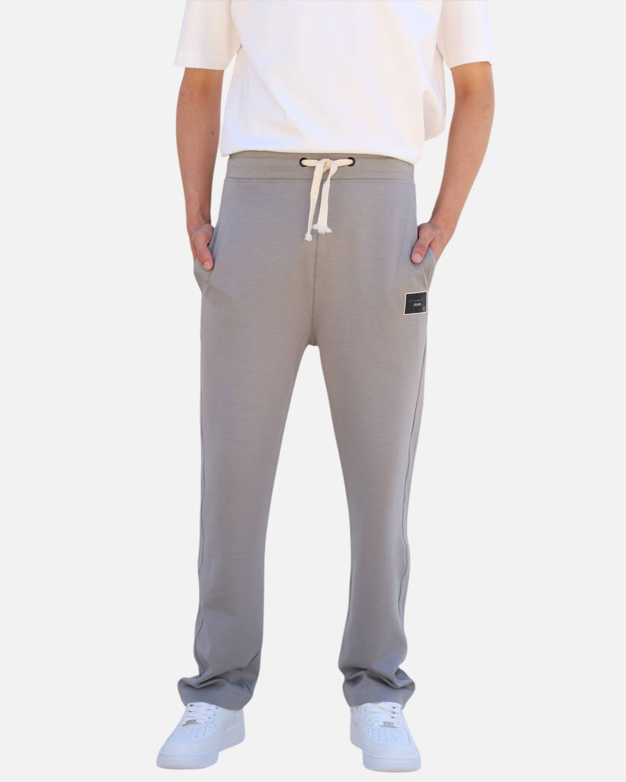 RUVR grey heavyweight fleece sweatpants with a woven label patch, side pockets, and Japanese-script drawstring.