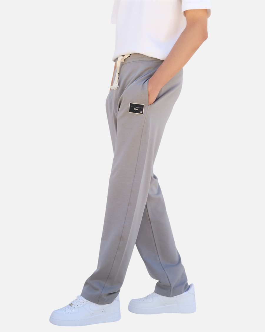RUVR grey heavyweight fleece sweatpants with a woven label patch on the thigh and Japanese-script drawstring detail.