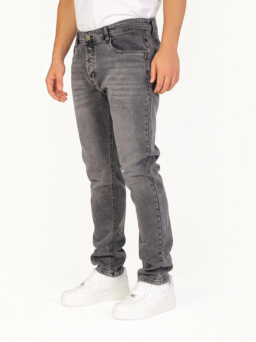 RUVR Haze Denim straight-leg jeans in a grey stonewash finish with five-pocket construction on a male model
