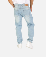 Back view of RUVR Haze Denim straight-leg jeans in light stonewash cotton with a tan leather brand patch.