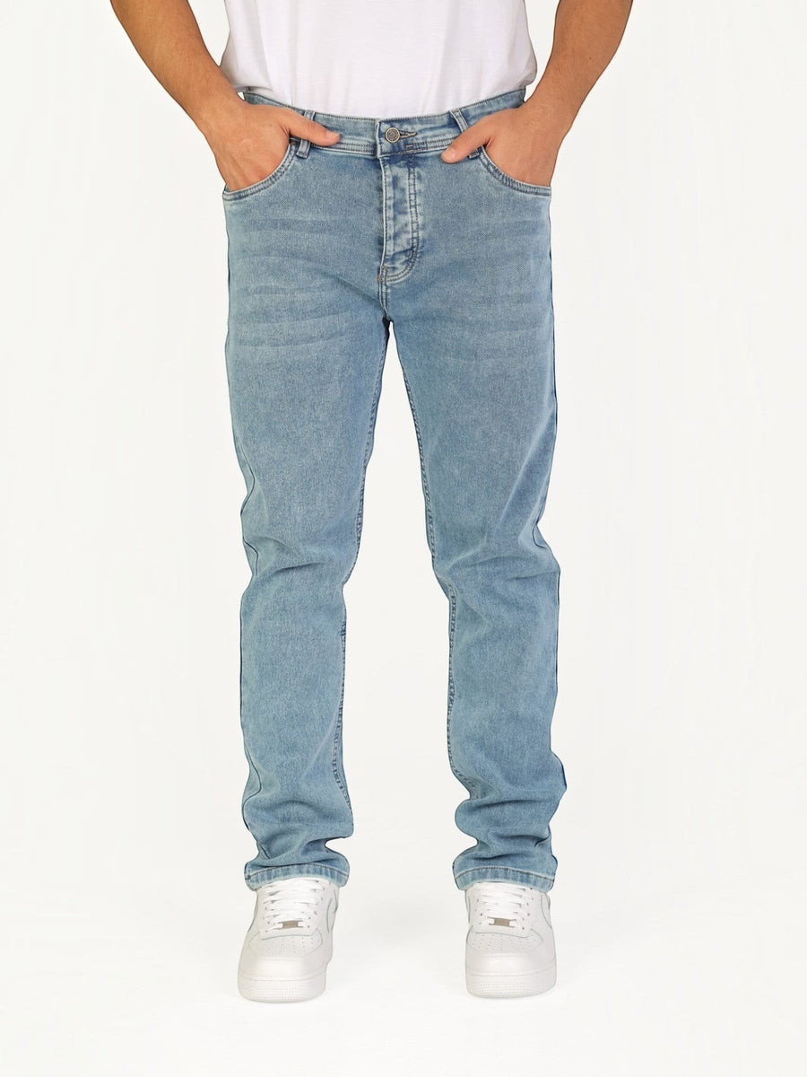 RUVR Haze Denim straight-leg jeans in a light blue stonewash finish with five-pocket construction on a model
