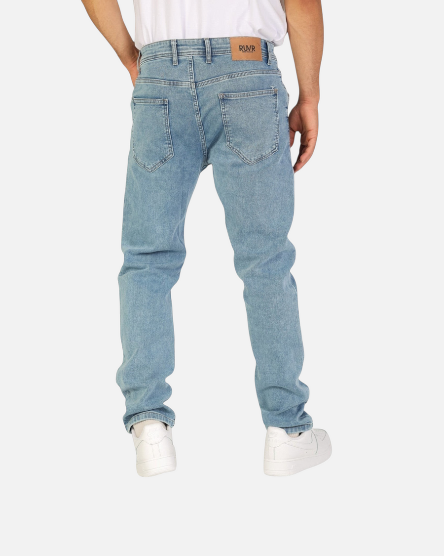 RUVR Haze Denim straight-leg jeans in light stonewash blue cotton with five-pocket styling and leather back patch.