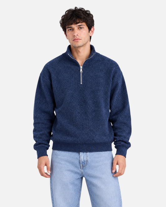 RUVR Drift half zip knit pullover in navy with a stand collar and relaxed fit worn by a man.