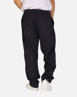 RUVR Urban Utility Pants in black with a relaxed fit, elastic waistband, and back pockets, worn by a model.