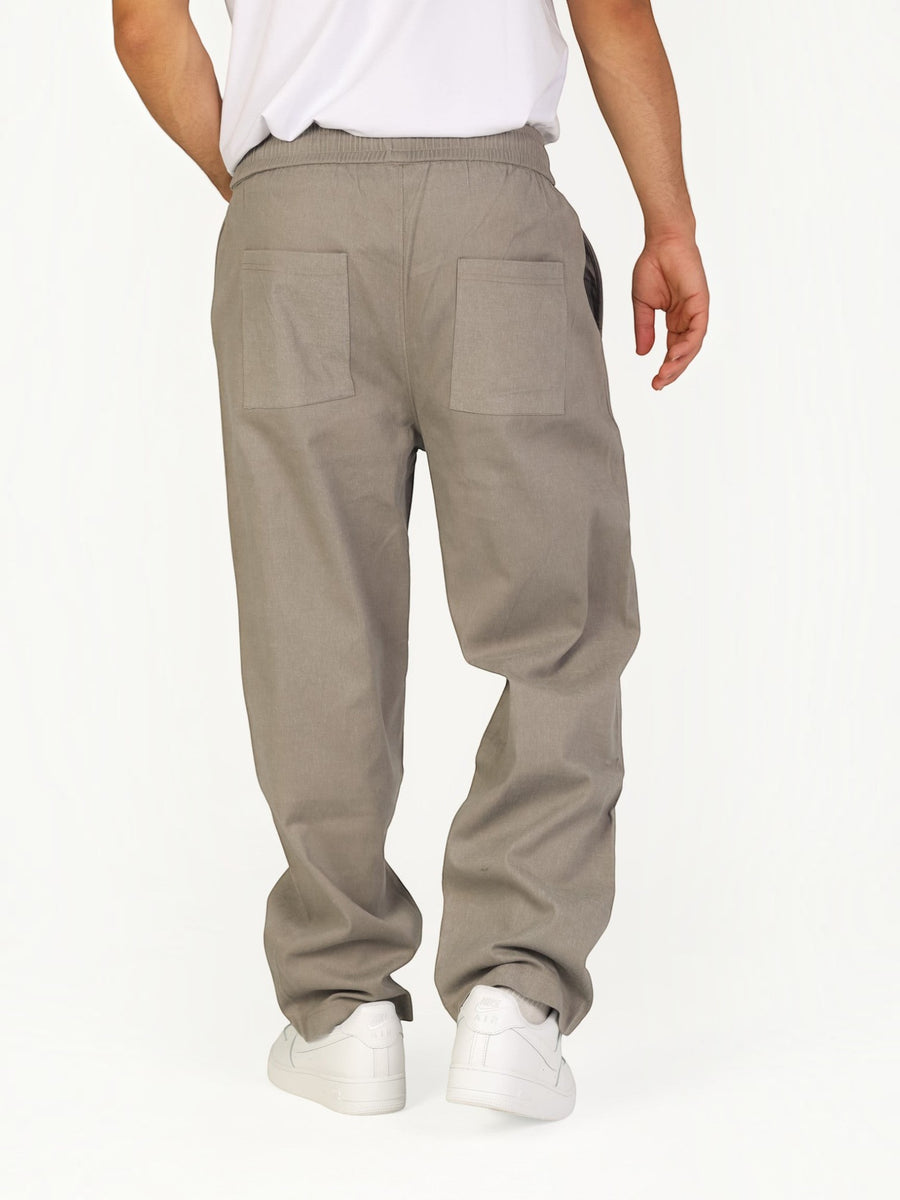 RUVR Urban Utility Pants in grey with an elastic drawstring waistband and relaxed fit, back view on a model.
