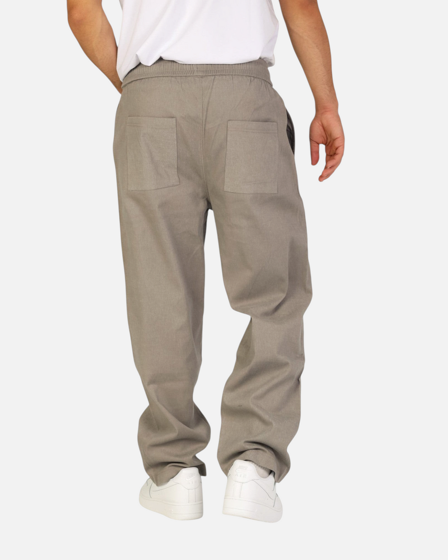 RUVR Urban Utility Pants in grey with an elastic drawstring waistband and relaxed fit, back view on a model.
