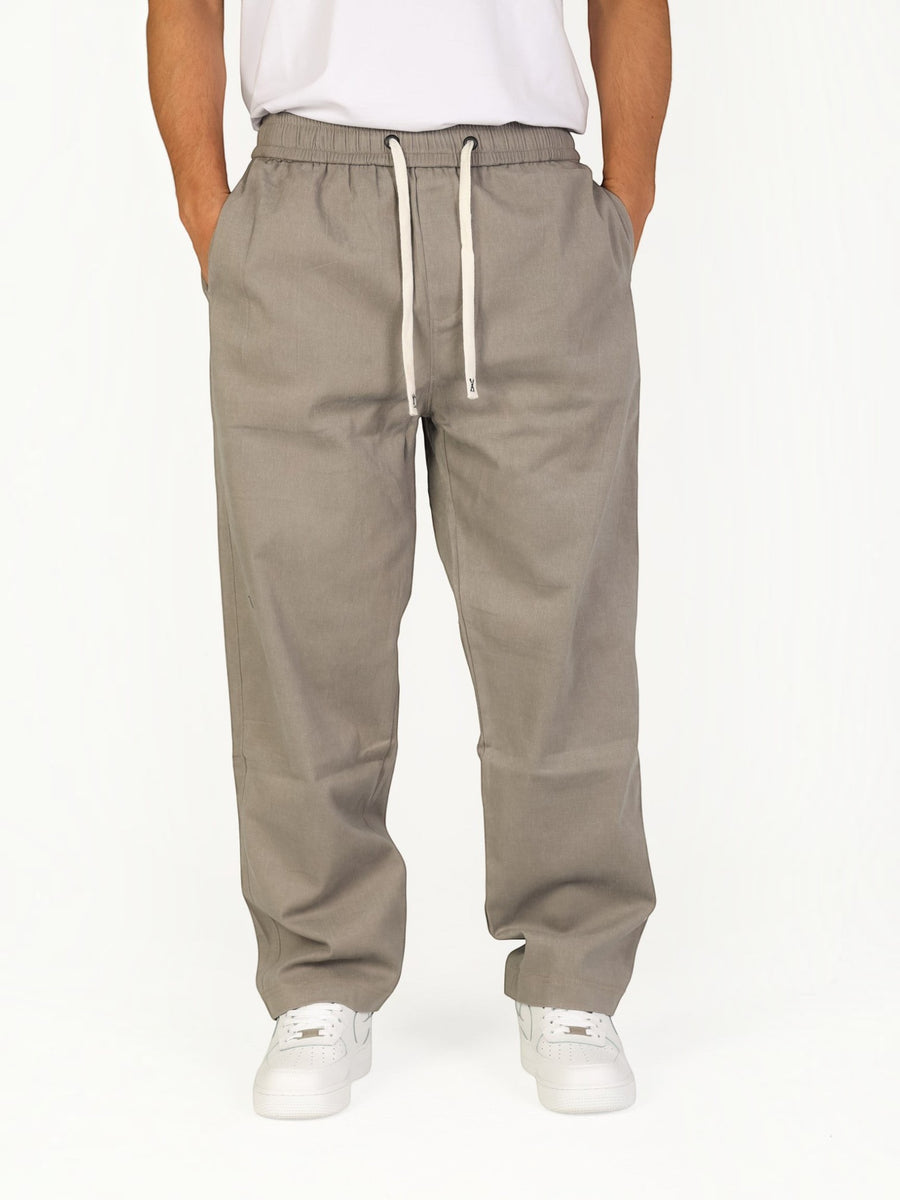 RUVR Urban Utility Pants in grey with an elastic drawstring waistband, worn by a man in a relaxed modern fit.