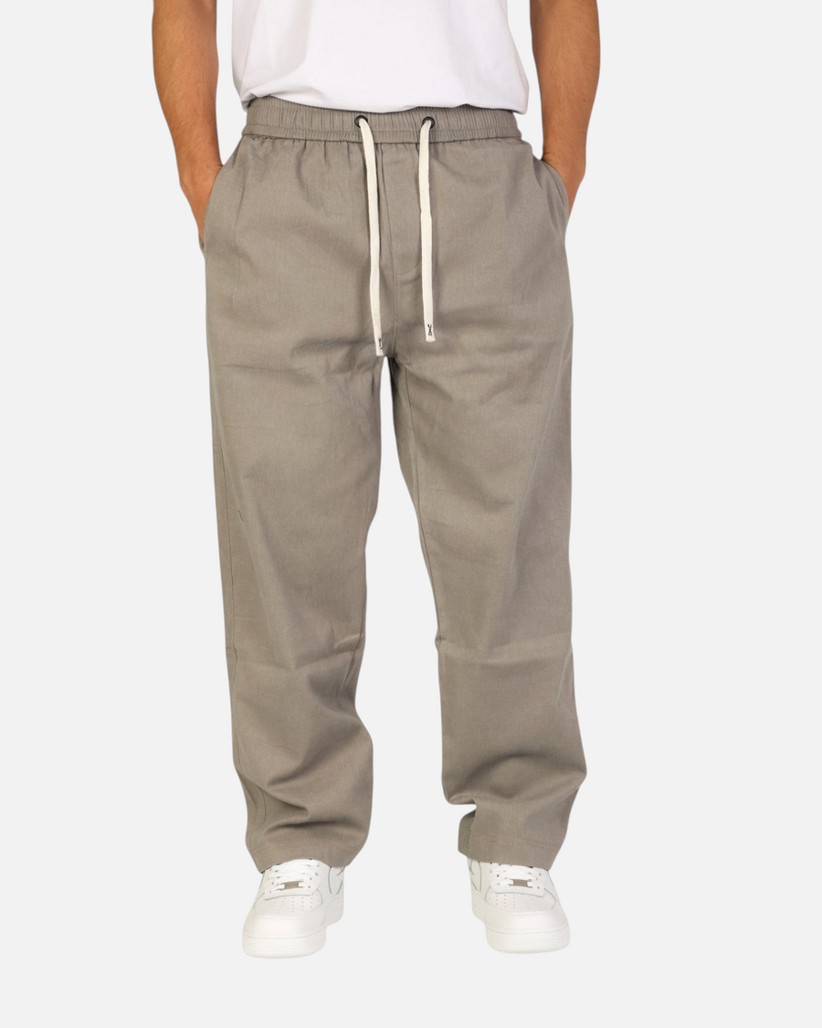 RUVR Urban Utility Pants in grey with an elastic drawstring waistband, worn by a man in a relaxed modern fit.