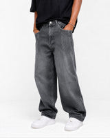 RUVR wide leg denim jeans in dark grey with curved seam construction and a relaxed fit worn by a model.
