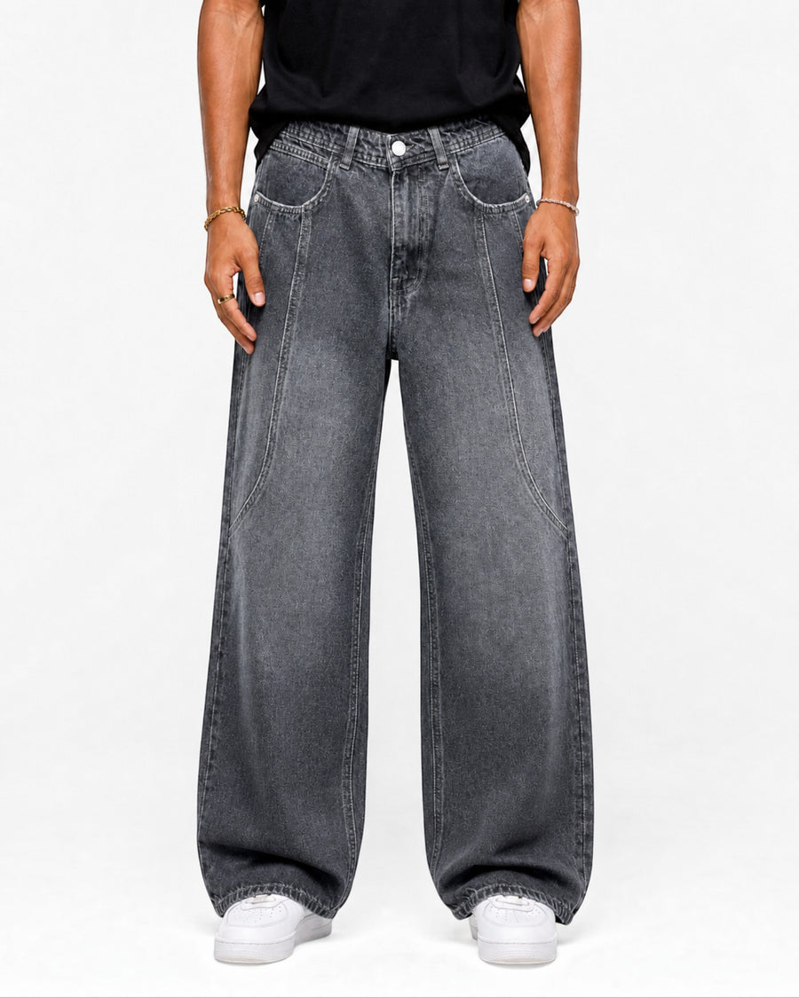 RUVR wide leg denim jeans in dark grey with curved seam construction worn by a model on a white background.